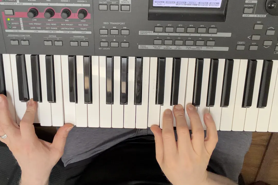 Henry's hands on his keyboard, the left hand on a bass note and the right on a chord.